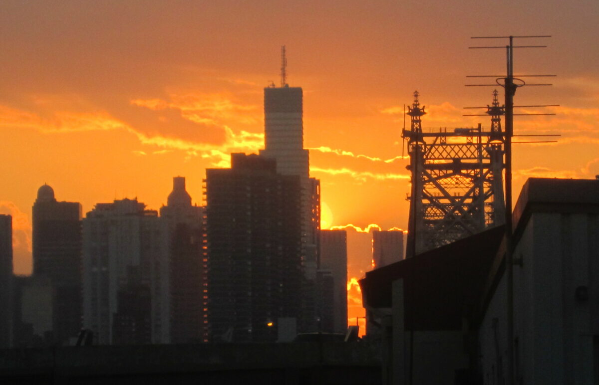 An image of a new york city looking hot with orange skies